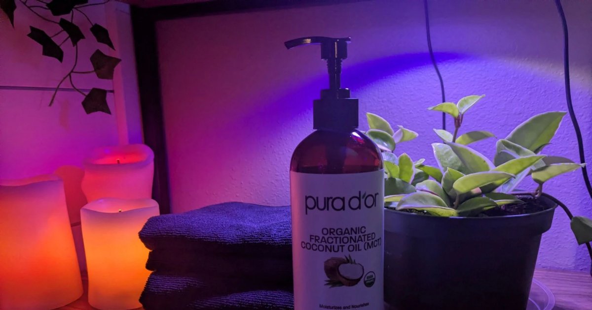 Softly lit treatment room with candles, fresh towels and a plant